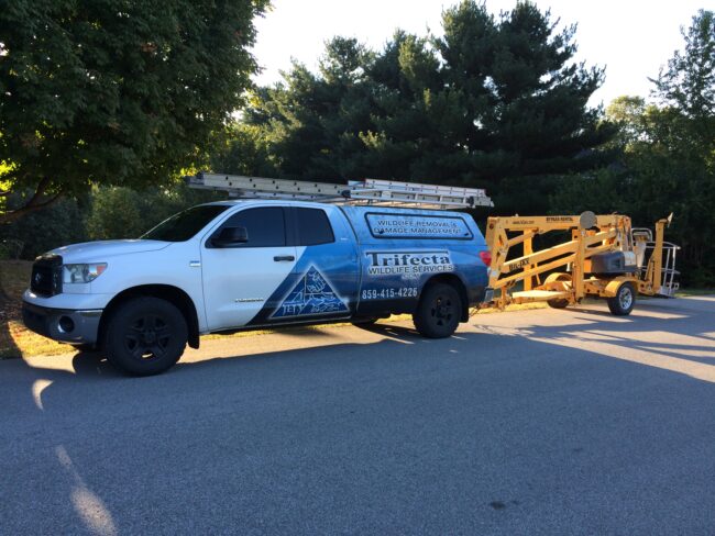 Trifecta Wildlife Services Truck With Aerial Lift The Trifecta Wildlife Services truck towing an aerial lift
