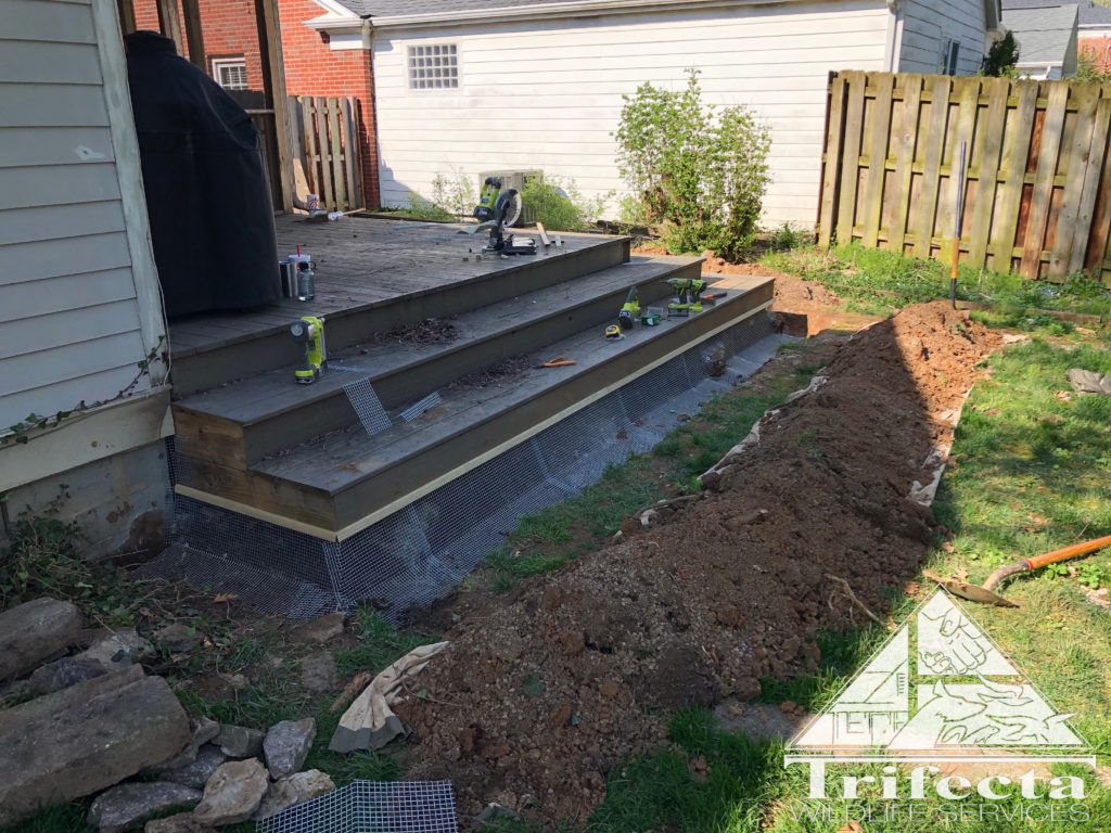 Dig barrier installation in progress with fencing laid into trench