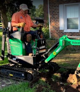 Team Trifecta's Kevin Mims operating a mini excavator