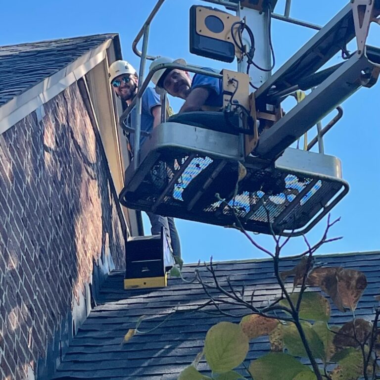 Trifecta Wildlife Team Members Chad and Clay Doing Aerial Lift Work