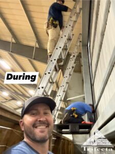 The team working hard on a bird net install in a horse arena.