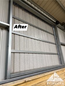 A completed bird net, StealthNet by Bird Barrier, on a horse arena window, with the slider closed.